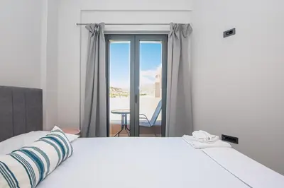 a bedroom with a bed and a view of a patio at Filitsa's Luxury House in Chania Town