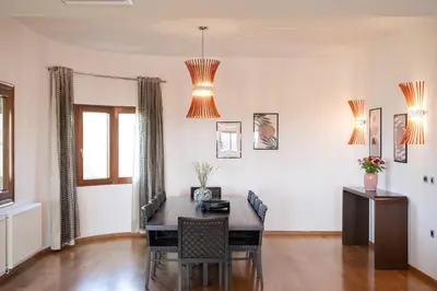 a dining room with a table and chairs at Fleur du sud - Villa in Chania in Korakiaí