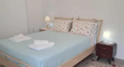 a bedroom with a bed with two towels on it at MariAdni Garden House in Kissamos