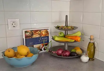 a counter with bowls of fruit and plates of food at MariAdni Garden House in Kissamos