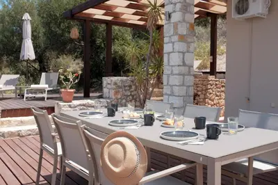 a white table and chairs on a patio at Everlane Seaview Villa in Arménoi