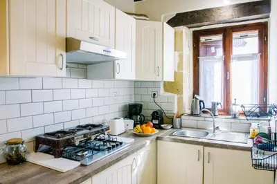 a white kitchen with a stove and a sink at Nature stone retreat between Balos & Elafonisi beach, contactless check-in, Mouri Nature House in Mouríon