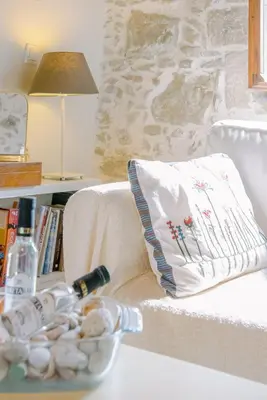 a white pillow sitting on a couch with a bowl of pills at Nature stone retreat between Balos & Elafonisi beach, contactless check-in, Mouri Nature House in Mouríon