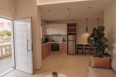 an open kitchen and living room with a couch at Cozy Living Apartments Chania close to the beach in Chania Town