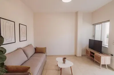 a living room with a couch and a tv at Cozy Living Apartments Chania close to the beach in Chania Town
