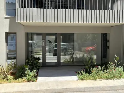 a front door of a building with plants and flowers at The Sandgate Elegant studio, Chania Seaside in Chania Town