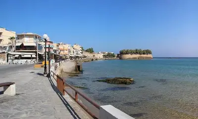 a beach with a fence next to the water at The Sandgate Elegant studio, Chania Seaside in Chania Town