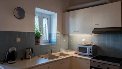 a kitchen with a sink and a microwave at Τhemis House in Chania Town