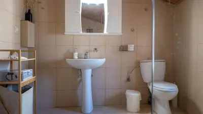 a bathroom with a sink and a toilet at Τhemis House in Chania Town