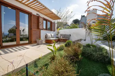 a garden with a patio and a house at Iasmos in Sfakiá