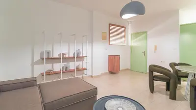 a living room with a couch and a table at Paleochora Central Apartments in Palaiochóra