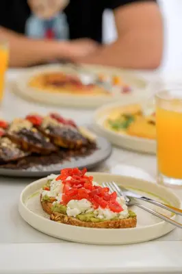 a table topped with plates of food and drinks at SugarDustApt Elegant Retreat 150m from the Sea in Chania Town