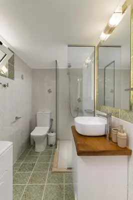 a bathroom with a sink and a toilet and a shower at SugarDustApt Elegant Retreat 150m from the Sea in Chania Town