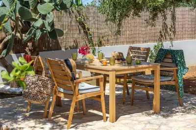 a wooden table and chairs in a yard at Murelos in Chania Town