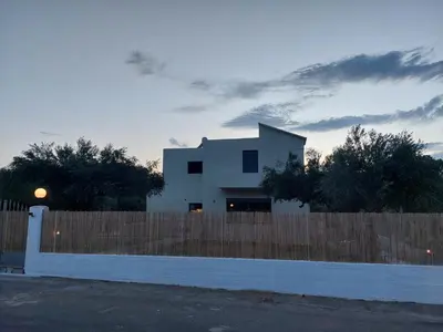 a white house behind a wooden fence at VENTO villa neriana in Khainderianá