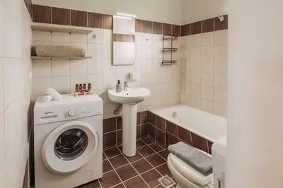a bathroom with a washing machine and a sink at Ibis Apartments Chania,close to the beach in Chania Town