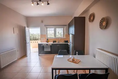 a kitchen and dining room with a table and chairs at Ibis Apartments Chania,close to the beach in Chania Town