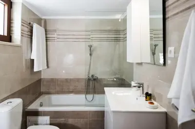a bathroom with a tub and a toilet and a sink at Villa Alia in Sfakiá