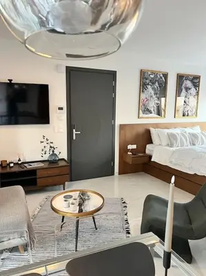 a living room with a bed and a coffee table at Hermes Studio - In the city just steps to the sea! in Chania Town