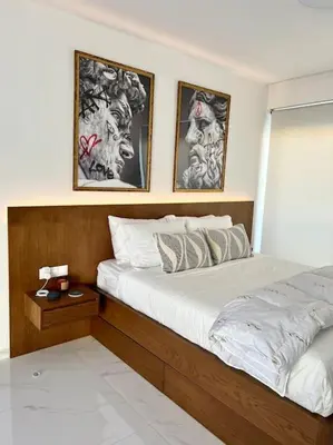 a bedroom with a bed and two pictures on the wall at Hermes Studio - In the city just steps to the sea! in Chania Town