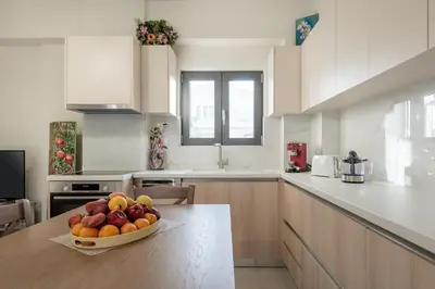 a bowl of fruit on a table in a kitchen at Newbulit Apartment 1km from the center of Chania in Chania Town