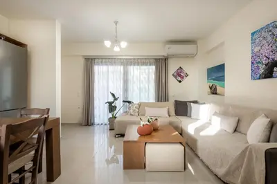 a living room with a couch and a table at Newbulit Apartment 1km from the center of Chania in Chania Town