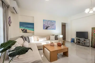a living room with a couch and a table at Newbulit Apartment 1km from the center of Chania in Chania Town