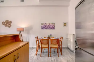 a kitchen and dining room with a table and chairs at Lavande in Chania Town