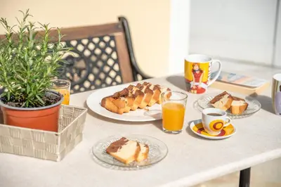 a table with plates of food and cups of orange juice at Lavande in Chania Town