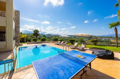 a swimming pool with a blue table on a patio at Villa Pasiphae 2 in Stalos