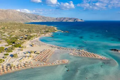 an aerial view of a beach with umbrellas and chairs at Villa Pasiphae 2 in Stalos