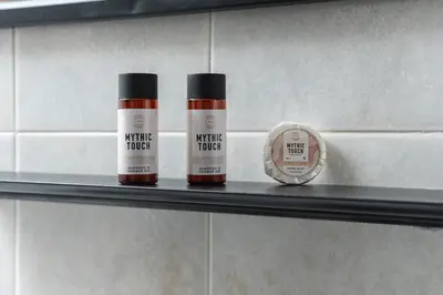 two bottles of paint on a shelf next to a clock at Viola Apartment in Kissamos