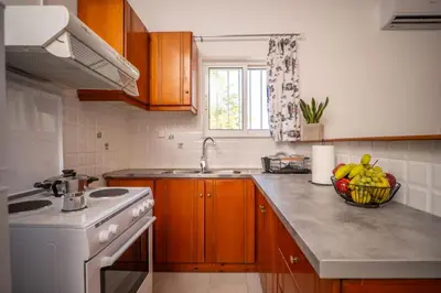 a kitchen with a bowl of fruit on the counter at Viola Apartment in Kissamos