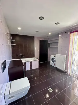 a bathroom with a toilet and a sink and a microwave at Ammos Family Villa in Daratso