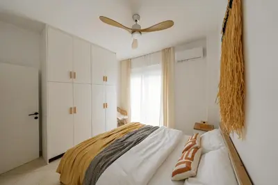 a bedroom with a bed and a ceiling fan at El Chacha Apartment in Galatás