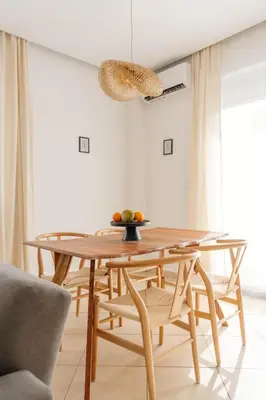 a dining room with a wooden table and chairs at El Chacha Apartment in Galatás
