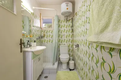 a bathroom with a toilet and a sink at Rastoni - Beach Family House in Chorafakia