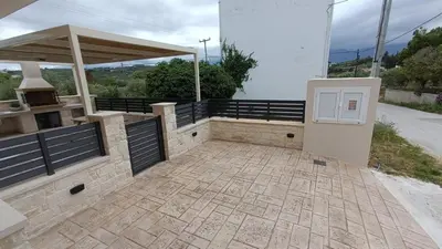a patio with a grill and a door on a building at Villa Terra Nuova in Kalyves