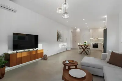 a living room with a couch and a tv at Villa Terra Nuova in Kalyves