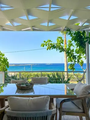 a dining table with a view of the ocean at Vista Mare apartments in Palaiochóra