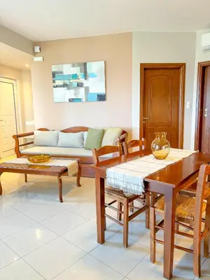 a living room with wooden tables and a couch at Vista Mare apartments in Palaiochóra
