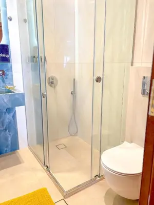a bathroom with a shower with a toilet at Vista Mare apartments in Palaiochóra
