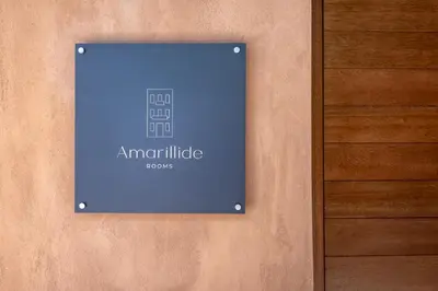a sign on the side of a building at Amarillide rooms in Chania Town