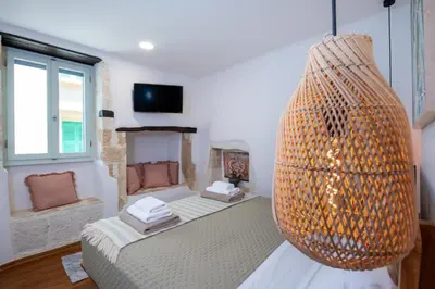 a room with a bed and a large chandelier at Casa Elysium - Chania Old City in Chania Town