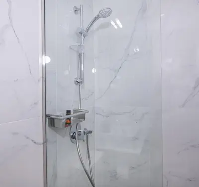 a bathroom with a shower with a glass door at Casa Elysium - Chania Old City in Chania Town