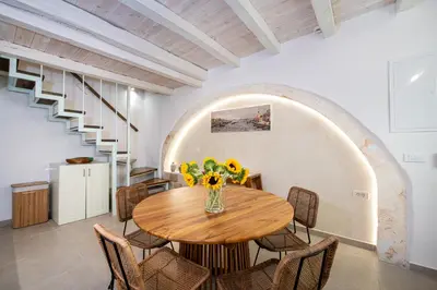 a dining room with a wooden table and chairs at Casa Elysium - Chania Old City in Chania Town
