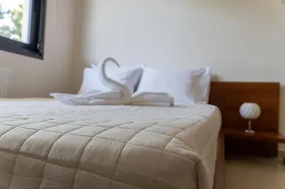 a bedroom with a white bed with a swan on it at Maisonette with Exclusive Private Parking in Chania Town