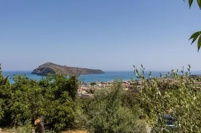 a view of a beach with a town and the ocean at Delta Sea View House in Plataniás