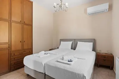 a bedroom with a white bed with two dishes on it at Delta Sea View House in Plataniás