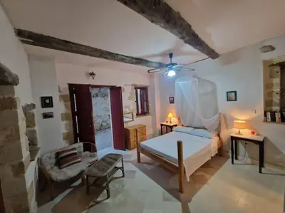 a bedroom with a bed and a couch and a table at KerAsh Villa Drapanias in Kissamos